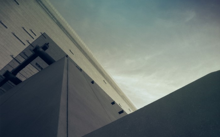 Abstract architecture against a cloudy sky