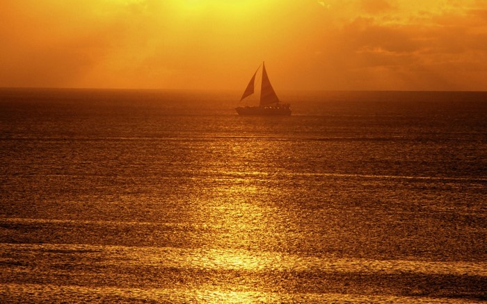 Sailboat on the sea at sunset