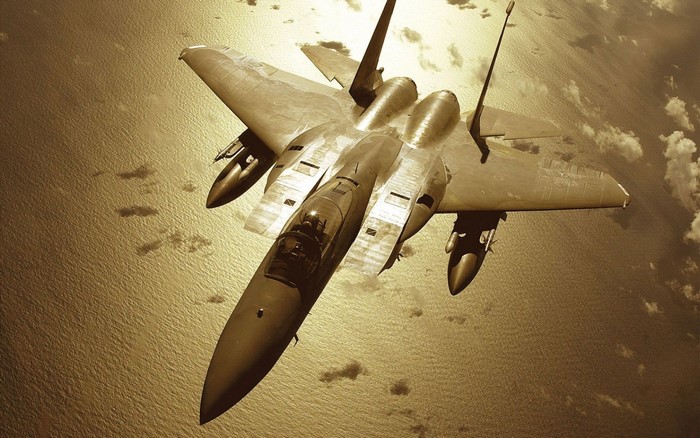 F-15 Eagle fighter jet flying over the ocean