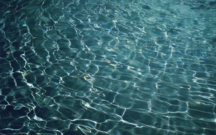 Sunlight reflecting on the surface of blue water