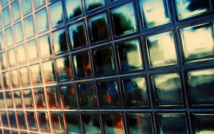 Glass blocks with reflections of trees and sky