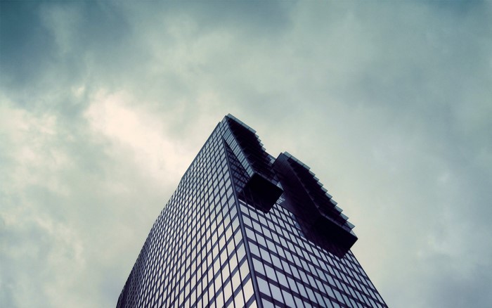 Modern skyscraper against a cloudy sky