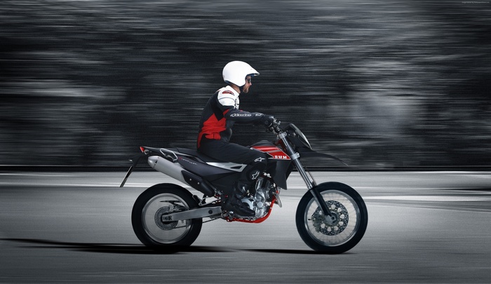 Man riding a SWM Super Dual 650 motorcycle