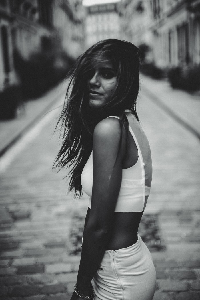 Woman in white top and shorts on a street