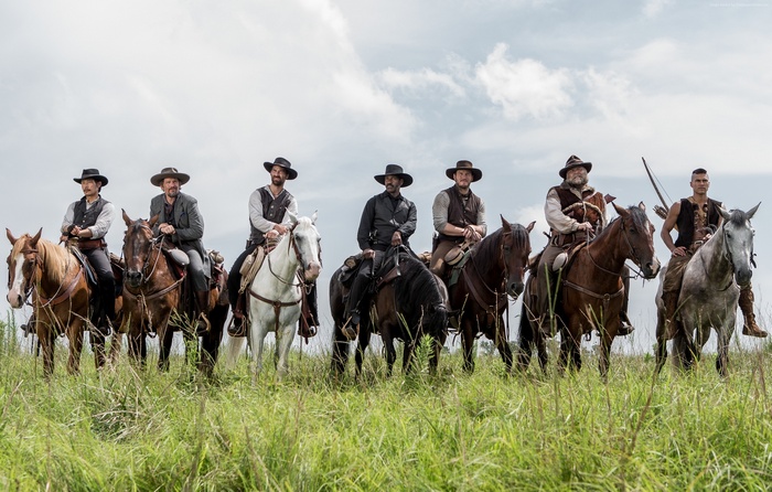The Magnificent Seven cast on horseback