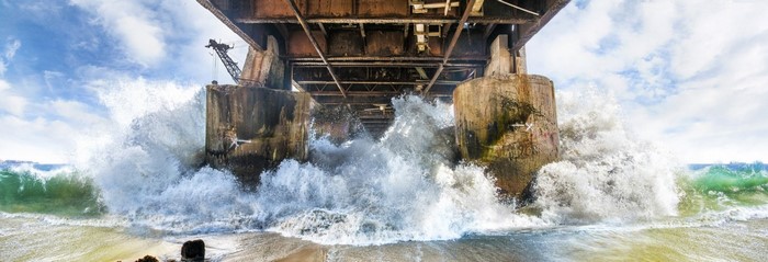 Waves crashing under an old pier in Vina del Mar, Chile