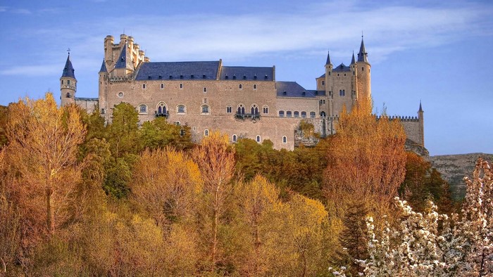 Alcázar of Segovia in autumn with colorful trees