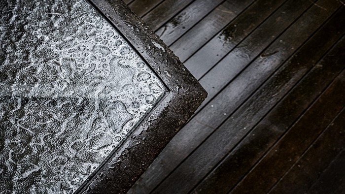 Table with water drops on wooden deck