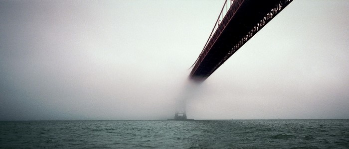 Golden Gate Bridge in fog over the ocean
