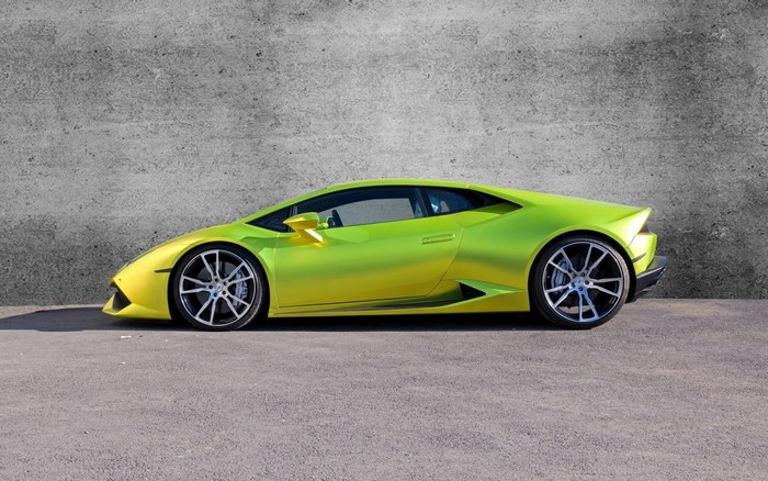Lime green Lamborghini Huracan parked against a concrete wall