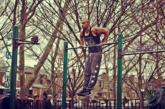 Man doing dips on parallel bars in a park