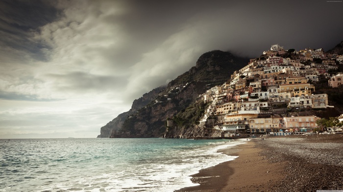 Positano coast with colorful buildings and cloudy sky