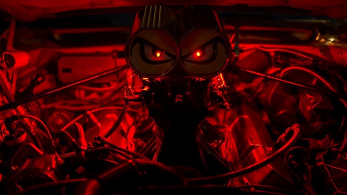 Close-up of a car engine with red lighting