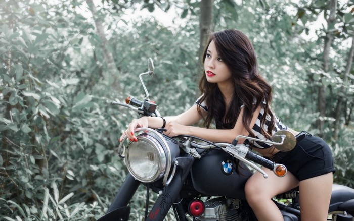 Woman Posing on BMW Motorcycle in Forest