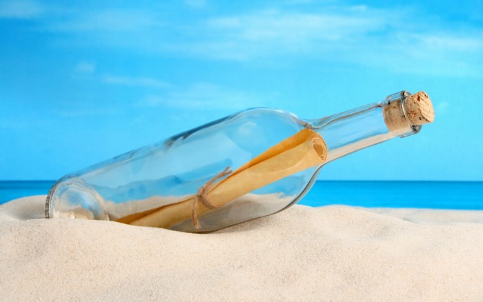 Message in a bottle on a sandy beach