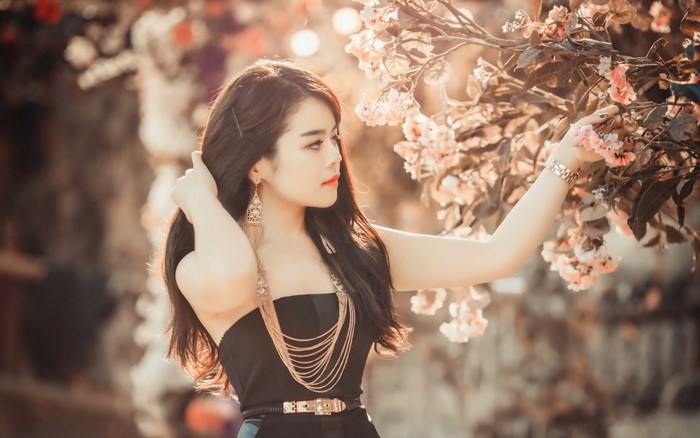 Asian woman in black dress with flowers