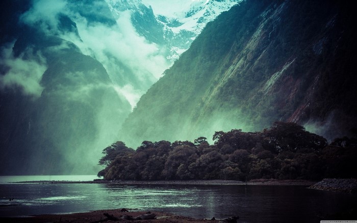 Misty Mountains Overlooking a Forested Shoreline