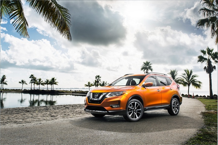 Orange Nissan Rogue SL crossover parked by the water