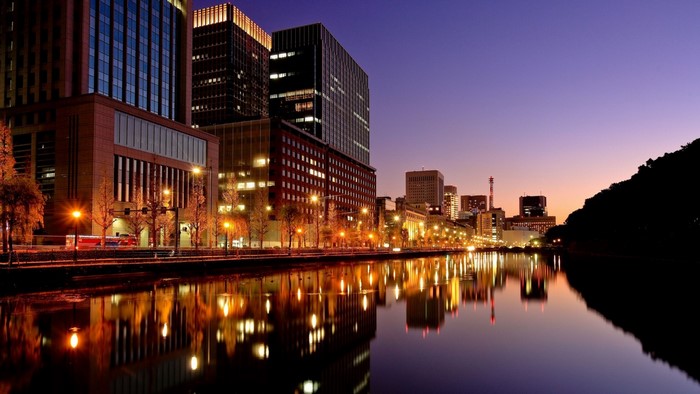 Cityscape at dusk with reflections in the water