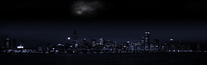 Monochrome cityscape at night with moon