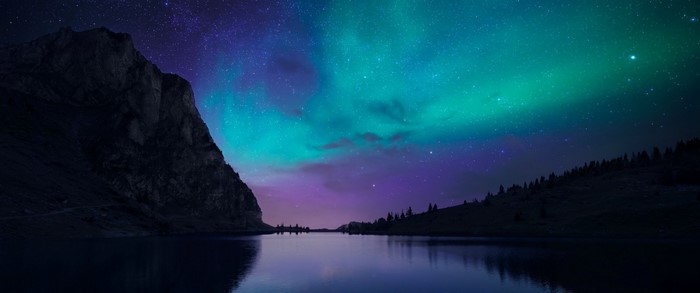Aurora Borealis over a mountain lake at night
