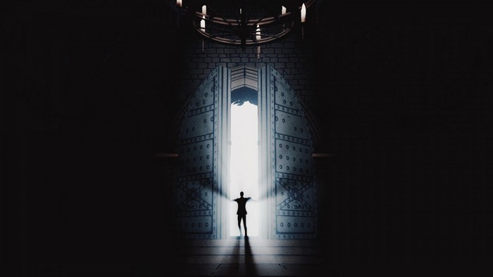 Man standing in front of open doors in darkness