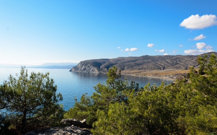 Coastal mountains and sea under a blue sky