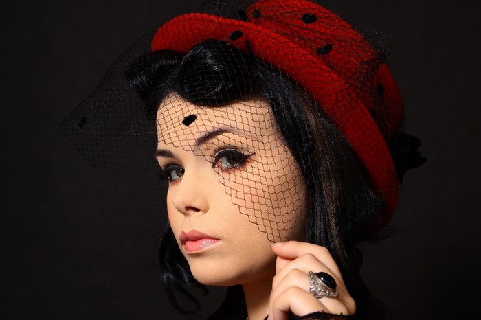 Woman in red polka dot hat and veil