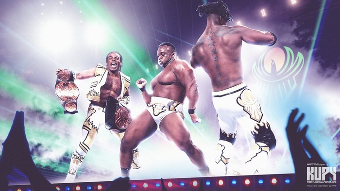 The New Day wrestlers holding championship belts on stage