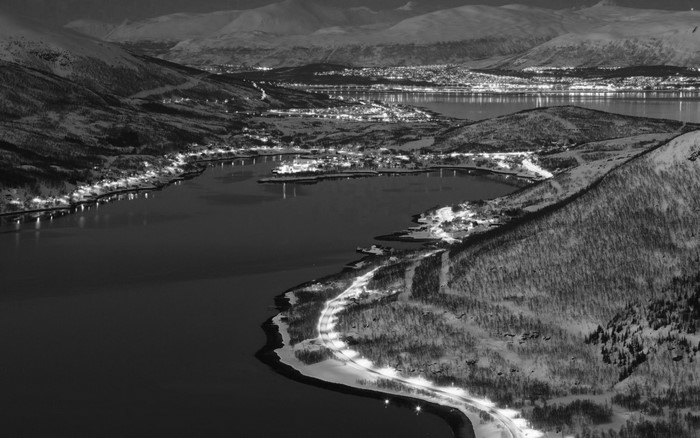 Aerial view of a coastal town at night in Norway
