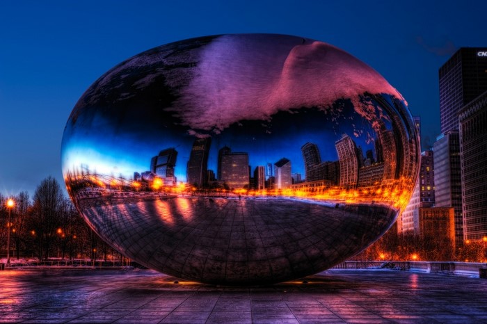 Cloud Gate sculpture reflecting Chicago skyline at night
