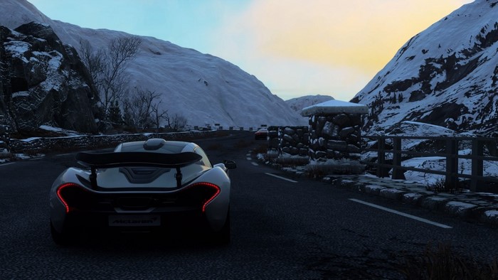 McLaren P1 driving on a snowy mountain road in Driveclub