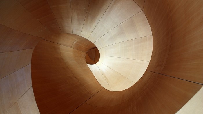 Abstract wooden spiral staircase with dramatic lighting
