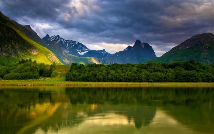 Mountain range reflected in a lake at dawn