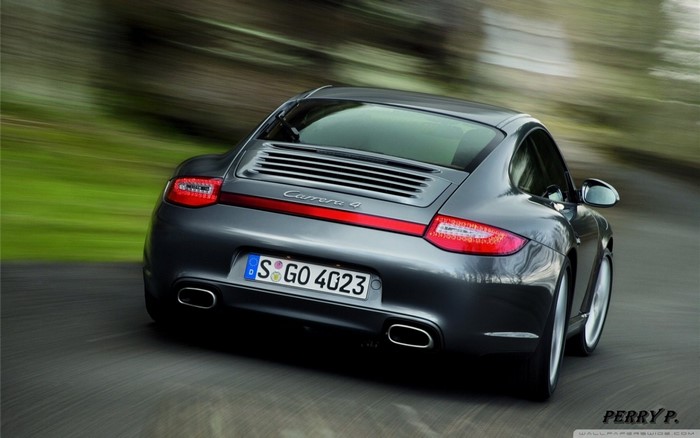 Porsche Carrera 4 driving on a road