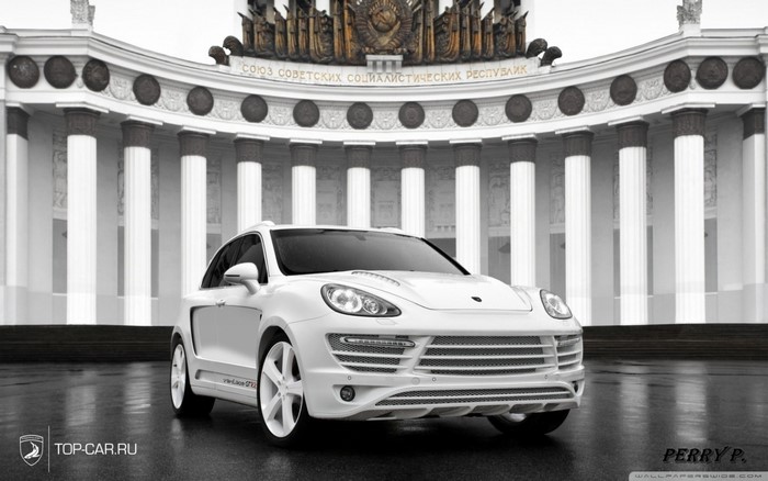 White Porsche Cayenne GT3 in front of Soviet-era building