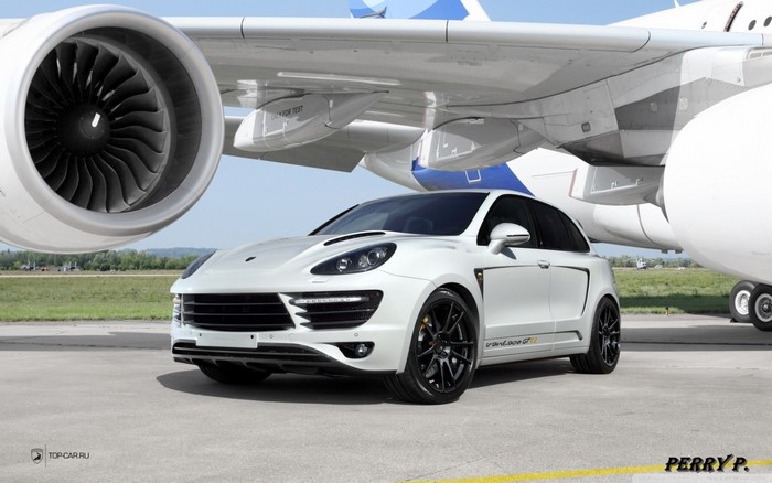 White Porsche Cayenne GT2 by Top Car next to airplane