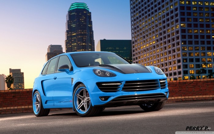 Blue Porsche Cayenne parked in a city at dusk
