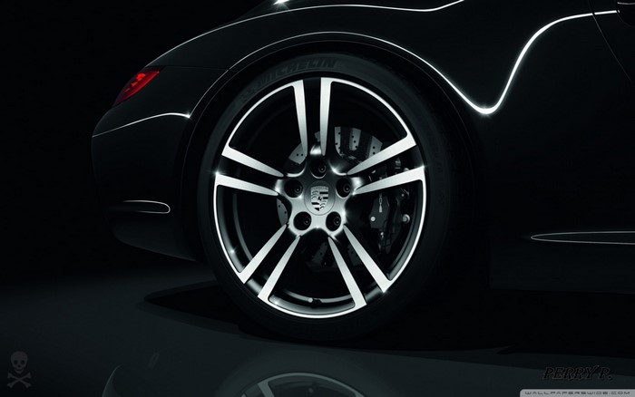 Black Porsche sports car wheel and fender