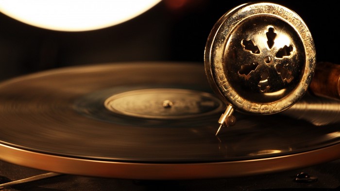 Close-up of a vintage gramophone needle on a spinning vinyl record