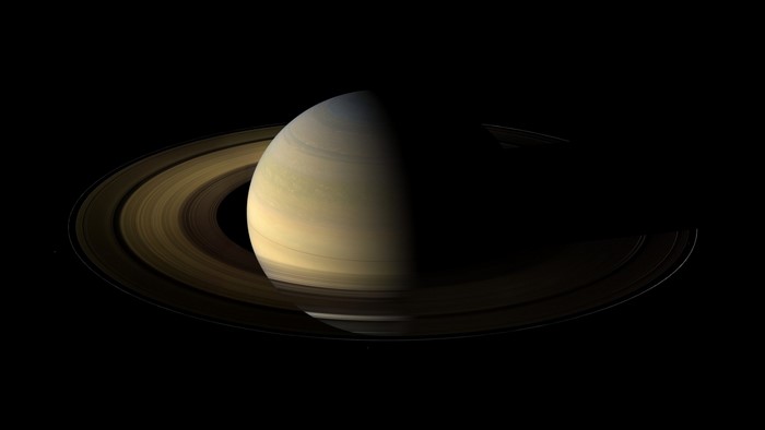 Saturn and its rings illuminated by sunlight