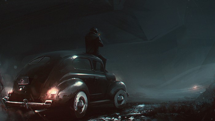 Man sitting on a vintage car at night
