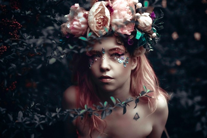 Woman with flower crown and face gems