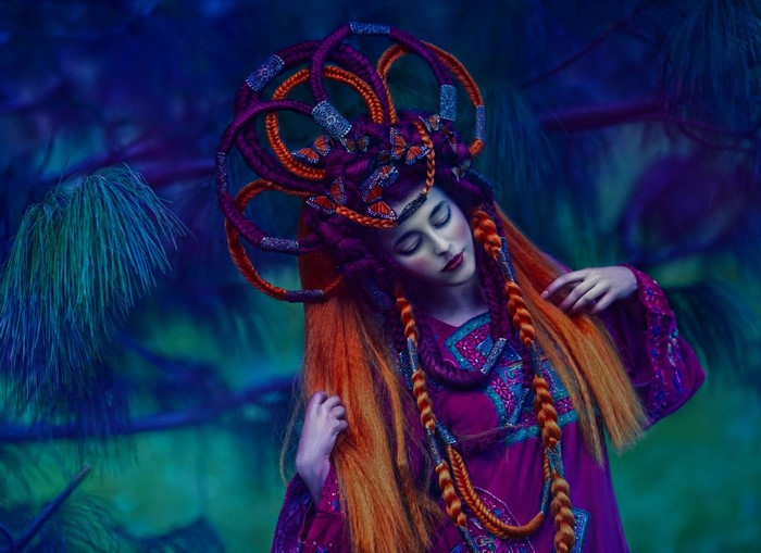 Woman with elaborate braided hair and butterflies