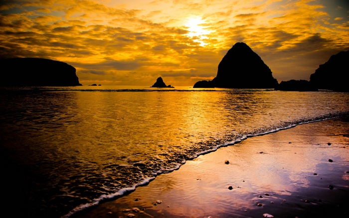 Sunset over the ocean with rock formations