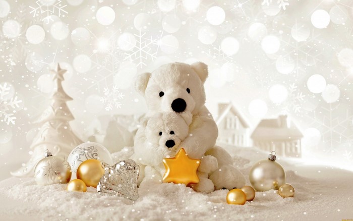 Two teddy bears with Christmas ornaments in the snow