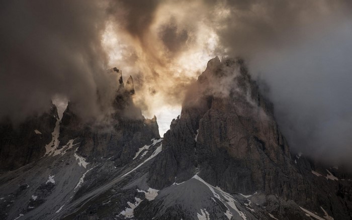 Dramatic clouds over jagged mountain peaks in the Dolomites