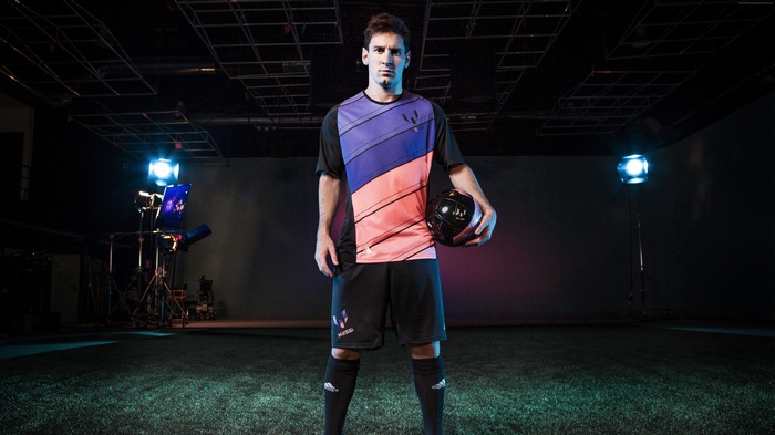 Lionel Messi holding a soccer ball