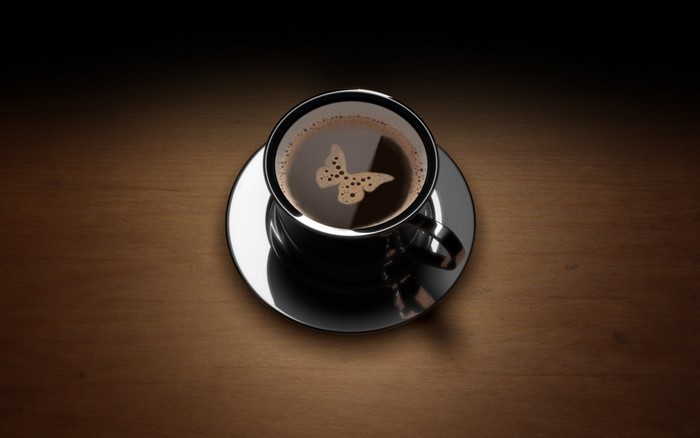 Coffee cup with butterfly foam art