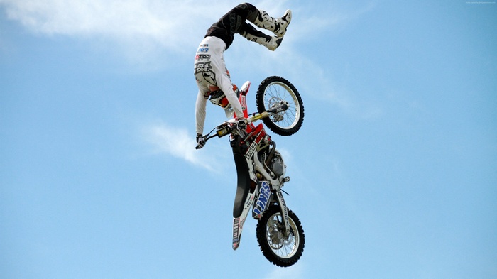 Motocross rider performing a stunt in the air